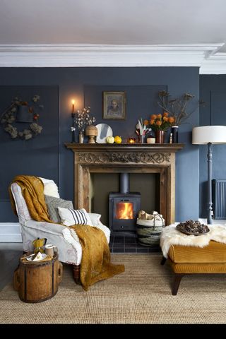 Cozy living room with dark walls, fireplace and mustard yellow accents