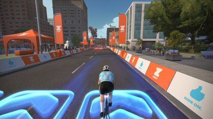 Avatar riding on Zwift's virtual roads which include boost pads