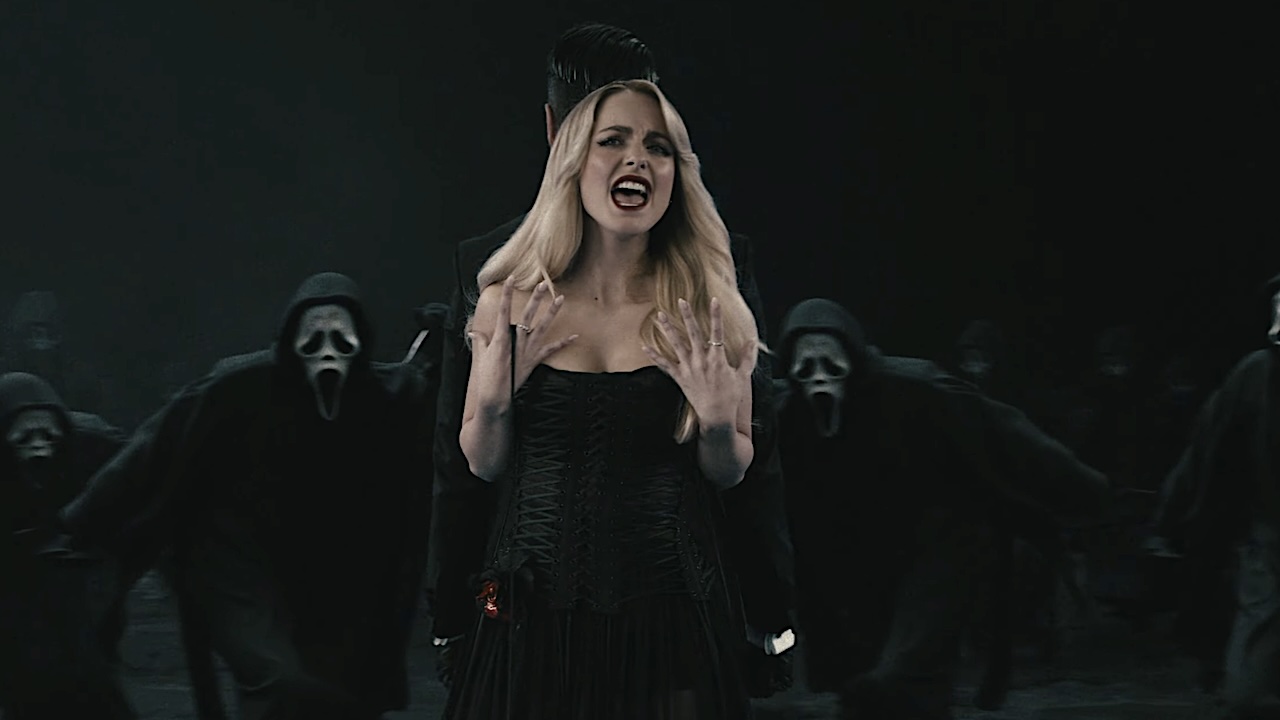 McKenna Grace singing as Ghostface killers surround her in music video for Ice Nine Kills Twisting the Knife