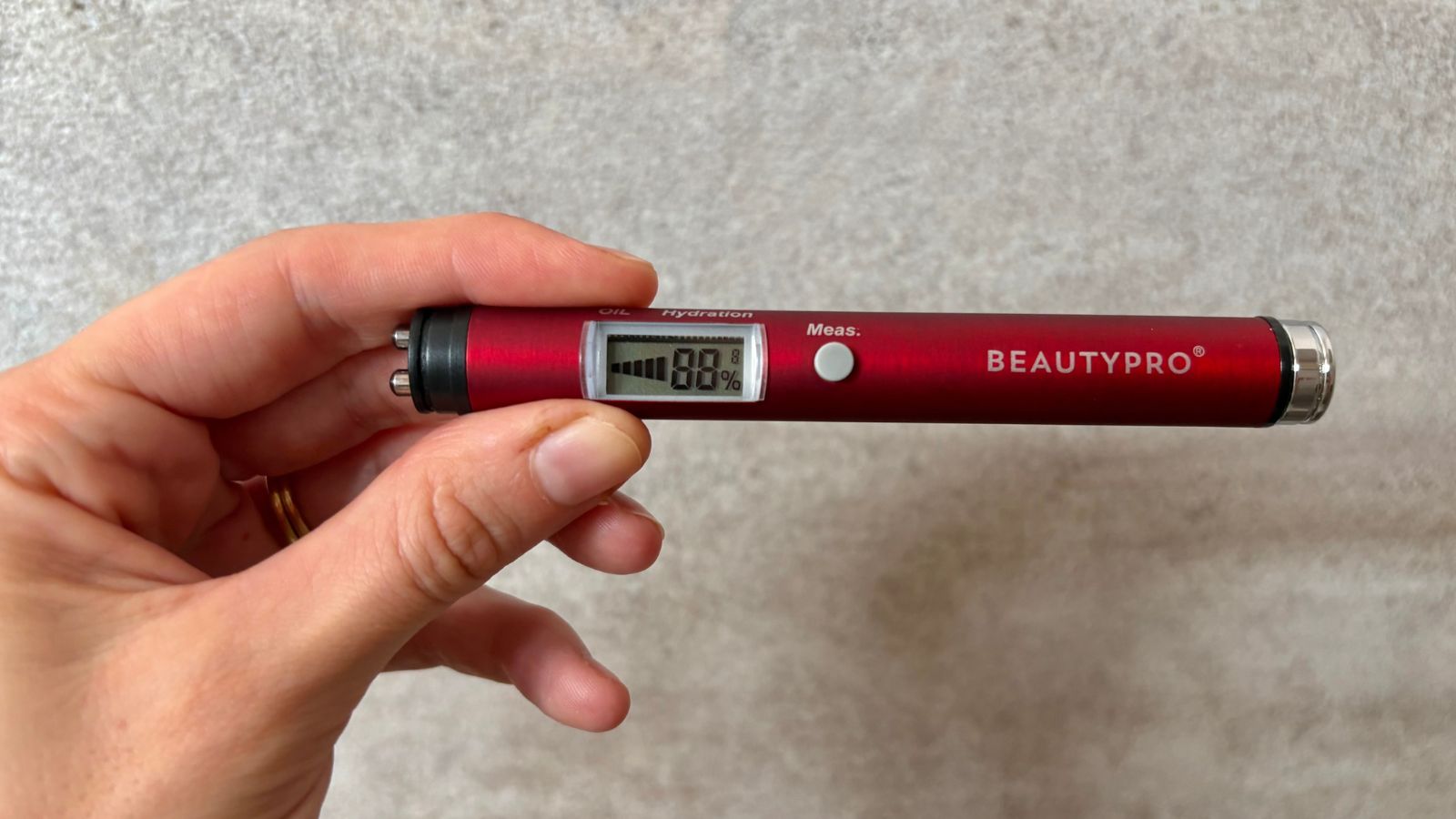 Jess using the BeautyPro Hydratest Skin Analysis Device to test her skin's hydration levels