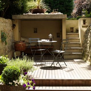 patio area with table and plants