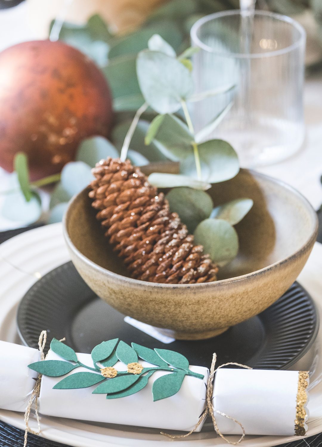 picture of scadi inspired tablesetting with pinecone and eucalyptus