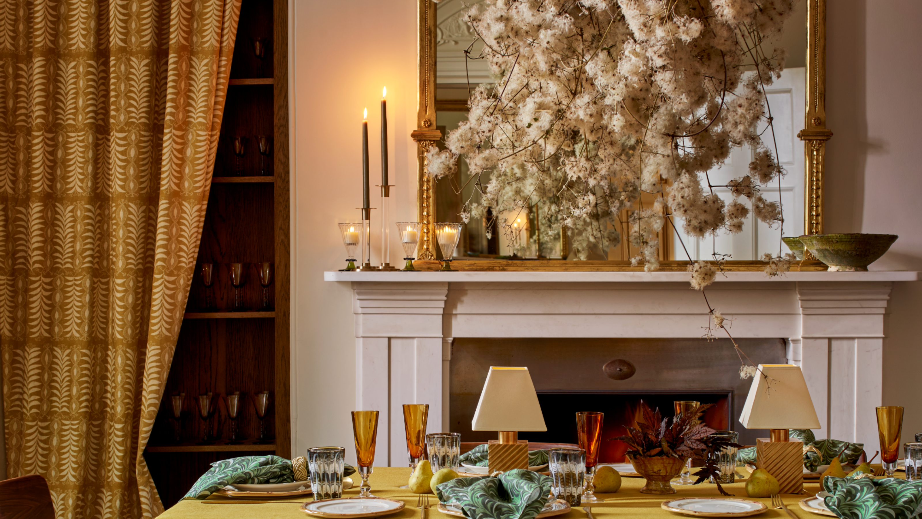 a decorative mantel with candles and decorative objects