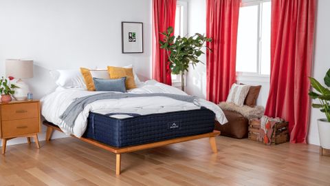 DreamCloud Mattress Review lead image, featuring a DreamCloud Mattress with sheets and pillows on top