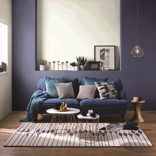 living room with wooden flooring and blue sofa set with cushions