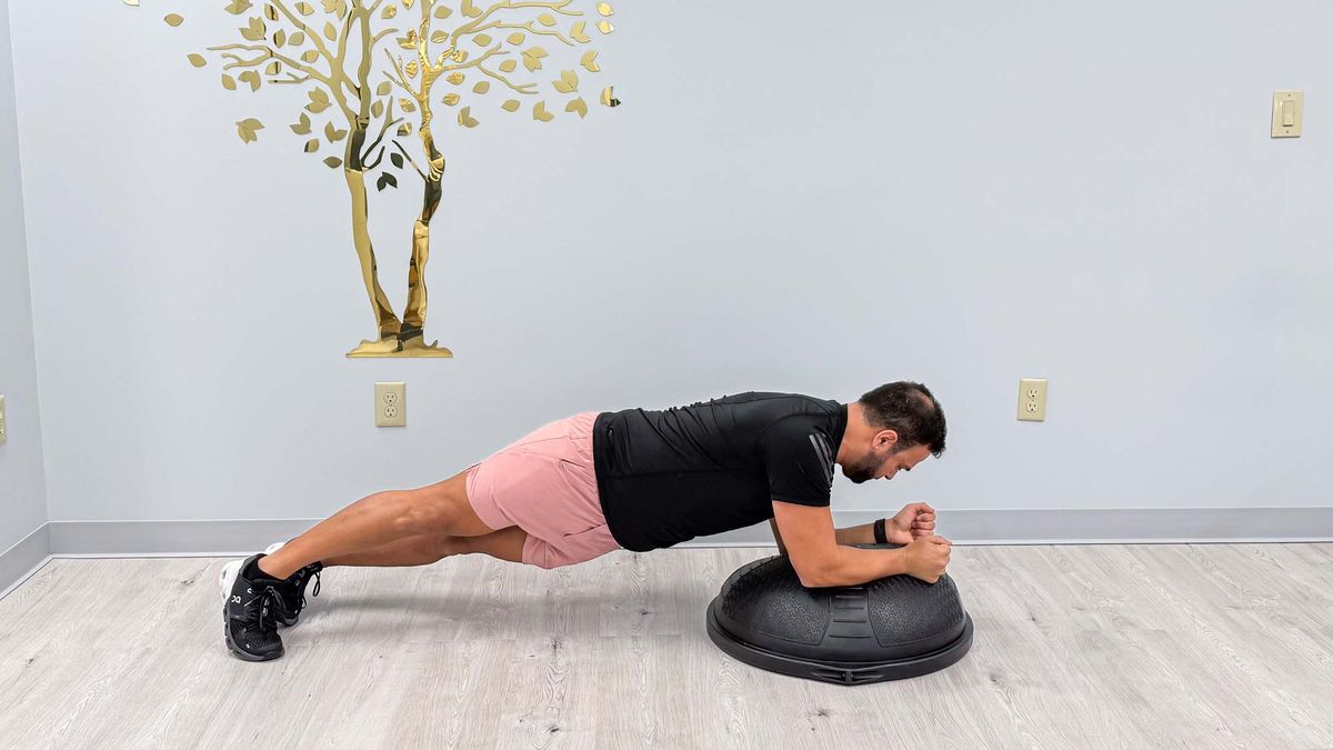 Nico Gonzalez holding a BOSU forearm plank