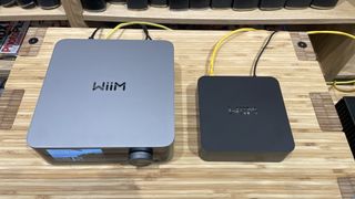 WiiM Ultra next to WiiM Pro Plus on wooden rack