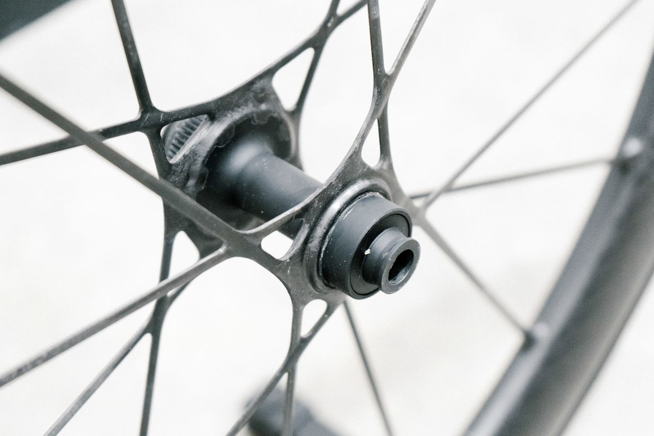An aero road wheel stands against a white wall