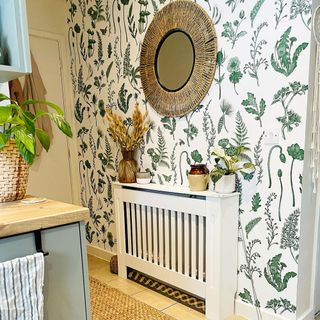 Botanical green and white wallpaper with gold mirror