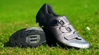 Shimano RX801 gravel shoe in silver pictured on grass