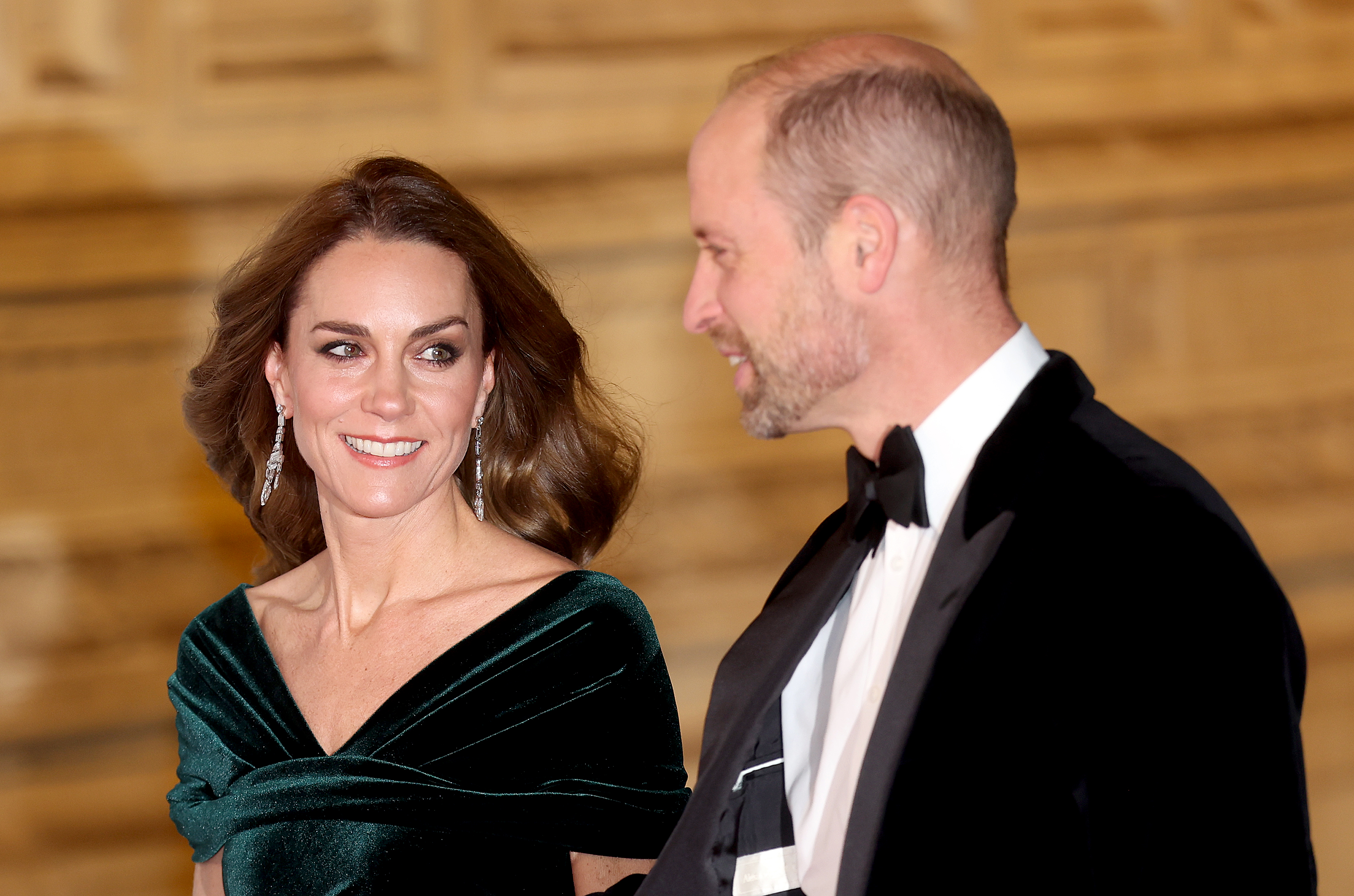 Kate Middleton wearing a green velvet gown and Prince William in a tux at the Royal Variety performance