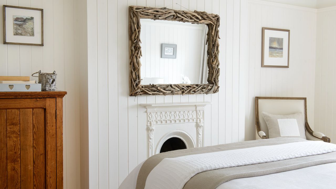 A bedroom with a fireplace and a large mirror