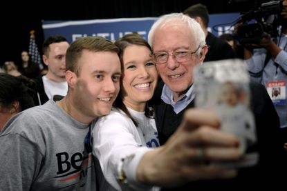 Bernie Sanders takes a selfie with supporters. 