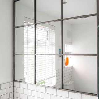 bathroom with oversized mirror white tiles