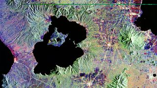 Colored satellite image of Philippine's Taal Lake and Volcano Island within it.