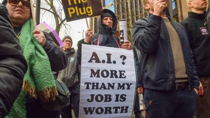 A protester holds anti-AI placards outside OpenAI offices in King's Cross during a march against unregulated Artificial Intelligence (AI) and data centres. 2026.