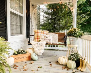 Fall porch decor with globe string lights - @thefinleyfarmhouse