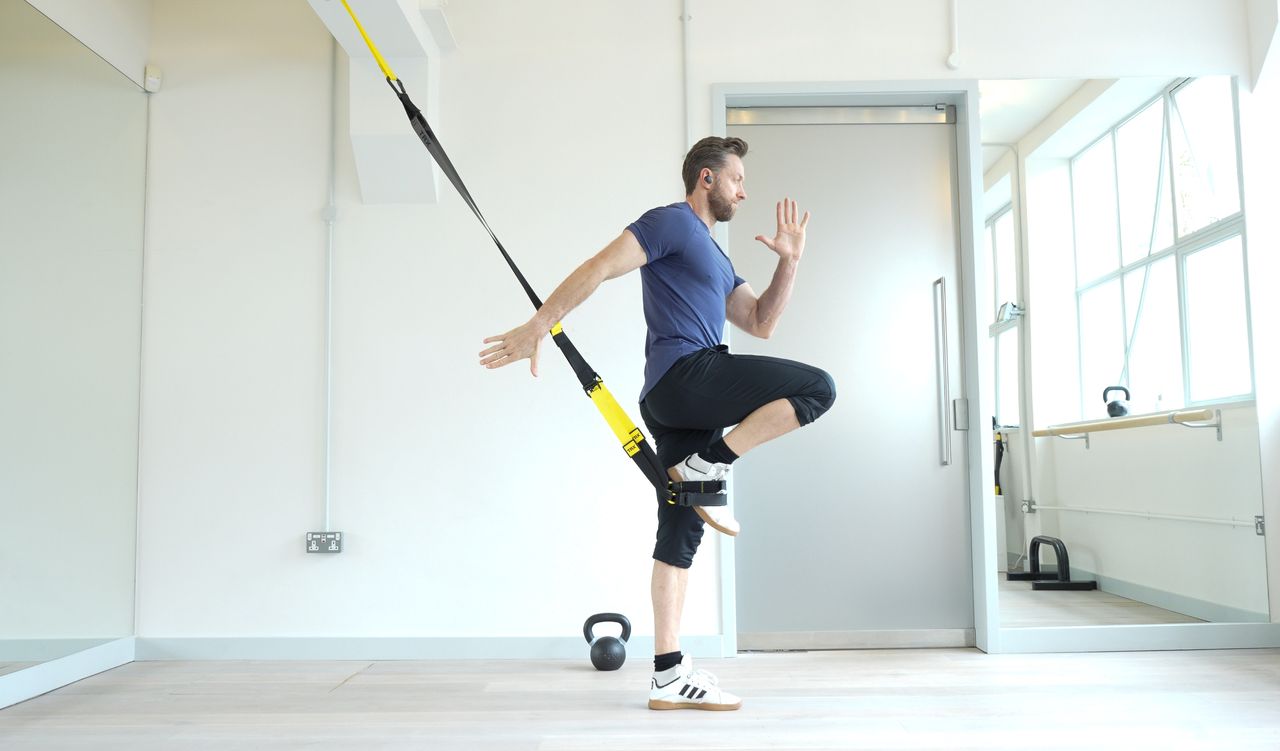Niko Algieri demonstrates one position of the TRX burpee