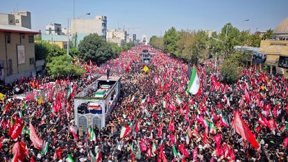 Mourners gather with flags to pay final respects to Iran's slain Supreme Leader Ayatollah Ali Khamenei during the third day of his funeral ceremonies