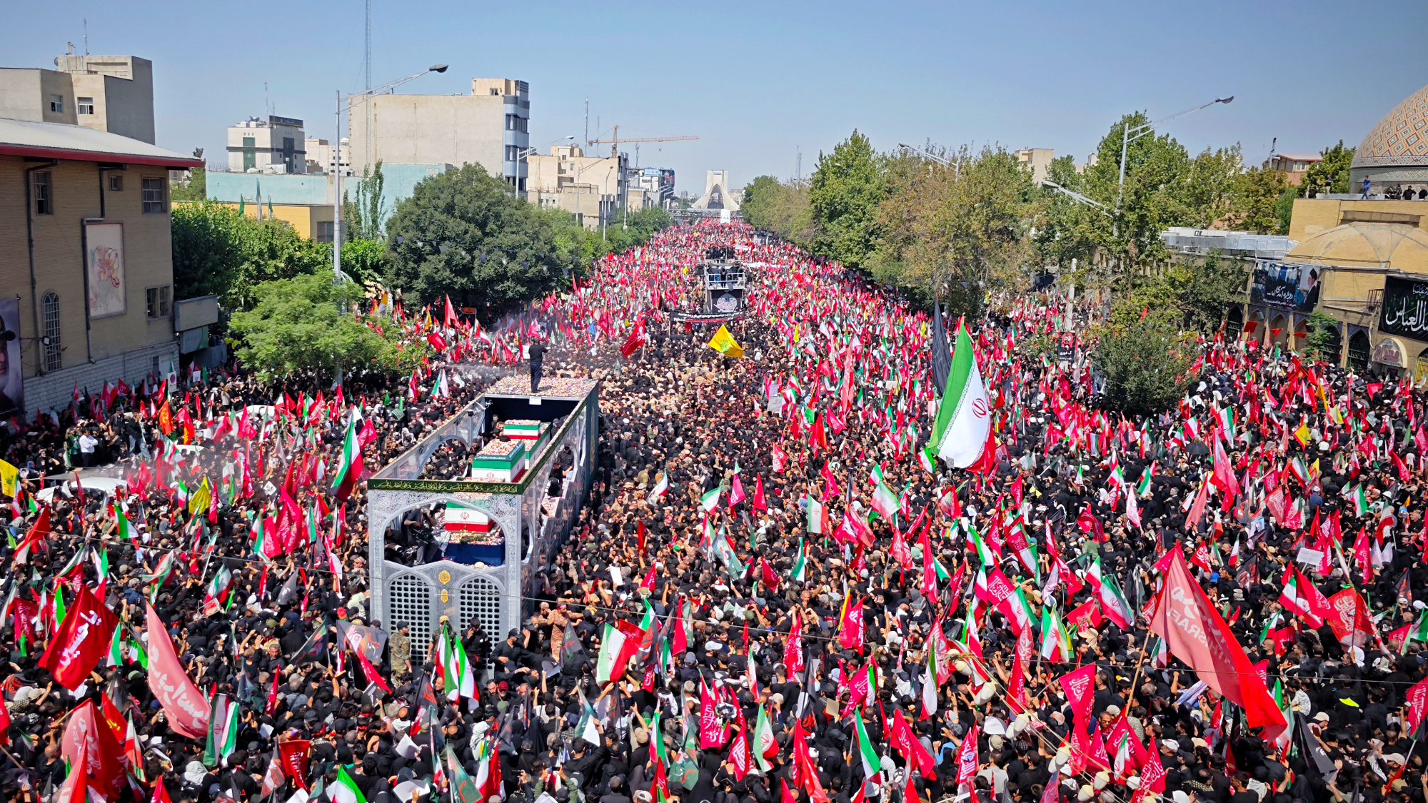 Mourners gather with flags to pay final respects to Iran's slain Supreme Leader Ayatollah Ali Khamenei during the third day of his funeral ceremonies 