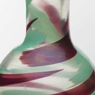 A glass vase with swirls of color.