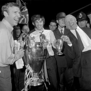Manchester United’s Pat Crerand, George Best and manager Matt Busby celebrate with the European Cup