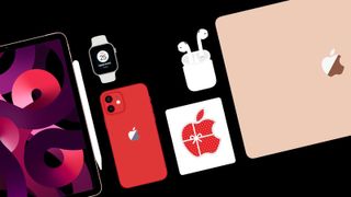 A flat lay of Apple products on a black background