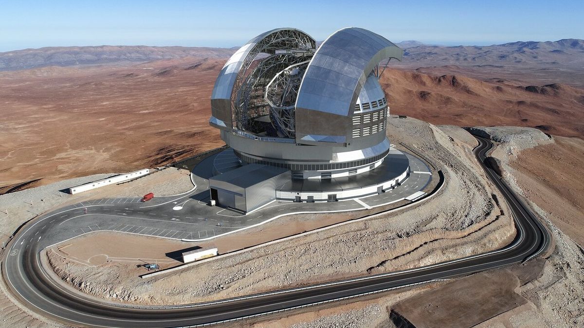 a silver dome on top of a mountain surrounded by desert