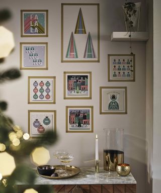 A gallery wall made up of framed Christmas cards using gold tape