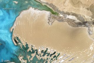 The Dardzha Peninsula of Turkmenistan, which is covered by desert sand dunes and juts into the Caspian Sea.