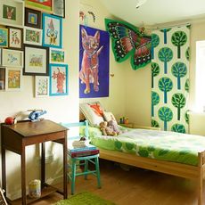 kids room with wall art work and wooden flooring