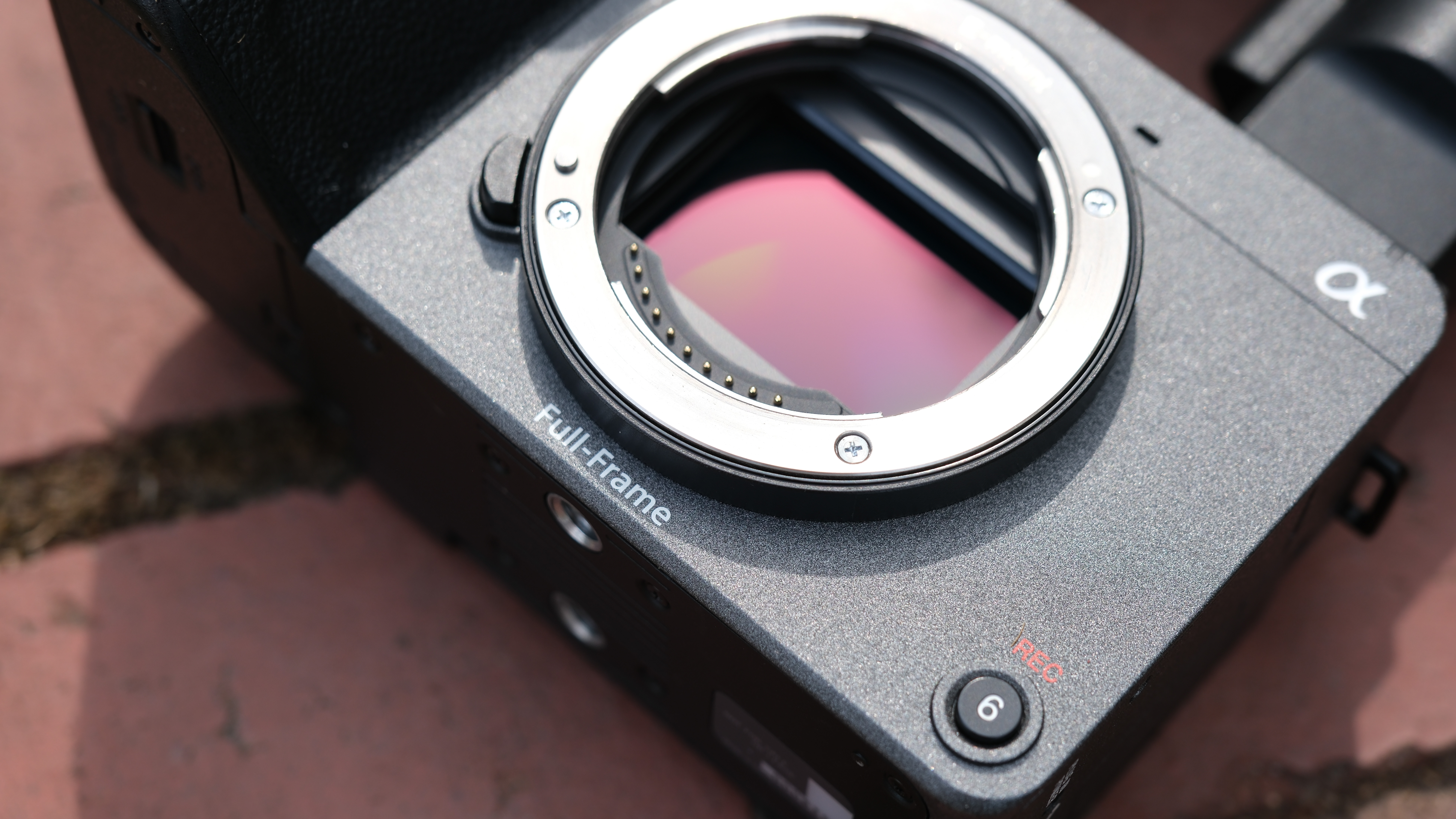 Close-up of the sensor on a Sony FX2 camera on a brick wall