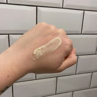 Lucy's hand showing swatch of Bobbi Brown Vitamin Enriched Face Base