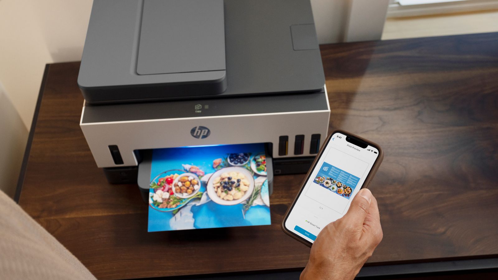 A person using the HP Smart app to print a business flyer on the HP Smart Tank printer.