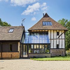 house exterior with clay roof tiles trees and sky