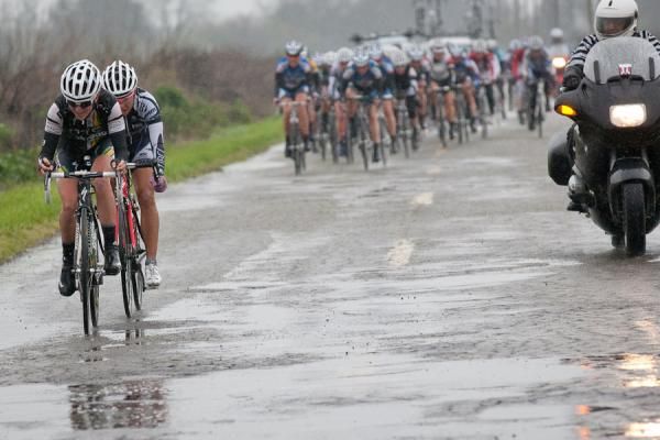 Amanda Miller (HTC-Highroad) and Carmen Small (TIBCO-To The Top) attempt to pull away from the women's field on the waterlogged Cox Ferry Road.
