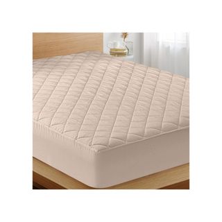 Fitted Mattress Pad on a bed.