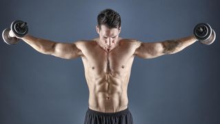 Man performing dumbbell lateral raises