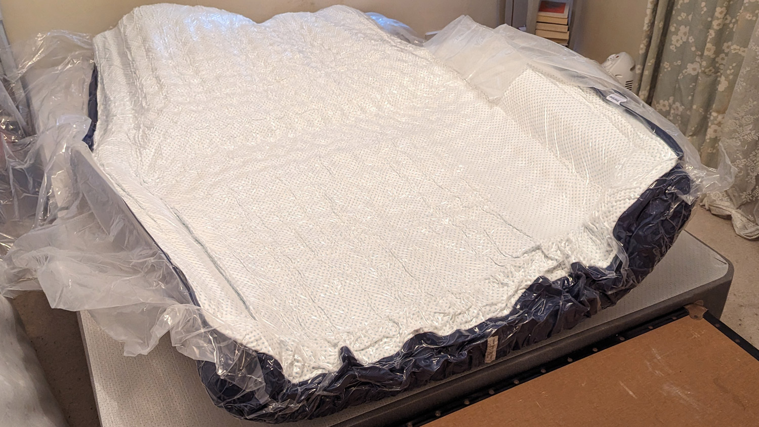 The Amerisleep AS3 Hybrid mattress, still vacuum-packed, on a bed