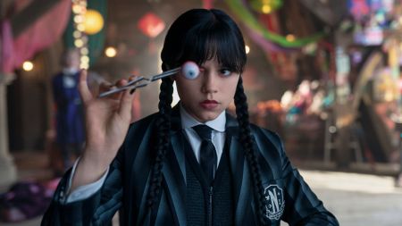 Jenna Ortega as Wednesday Adams in Wednesday season 2, see here holding an eyeball with tweezers.