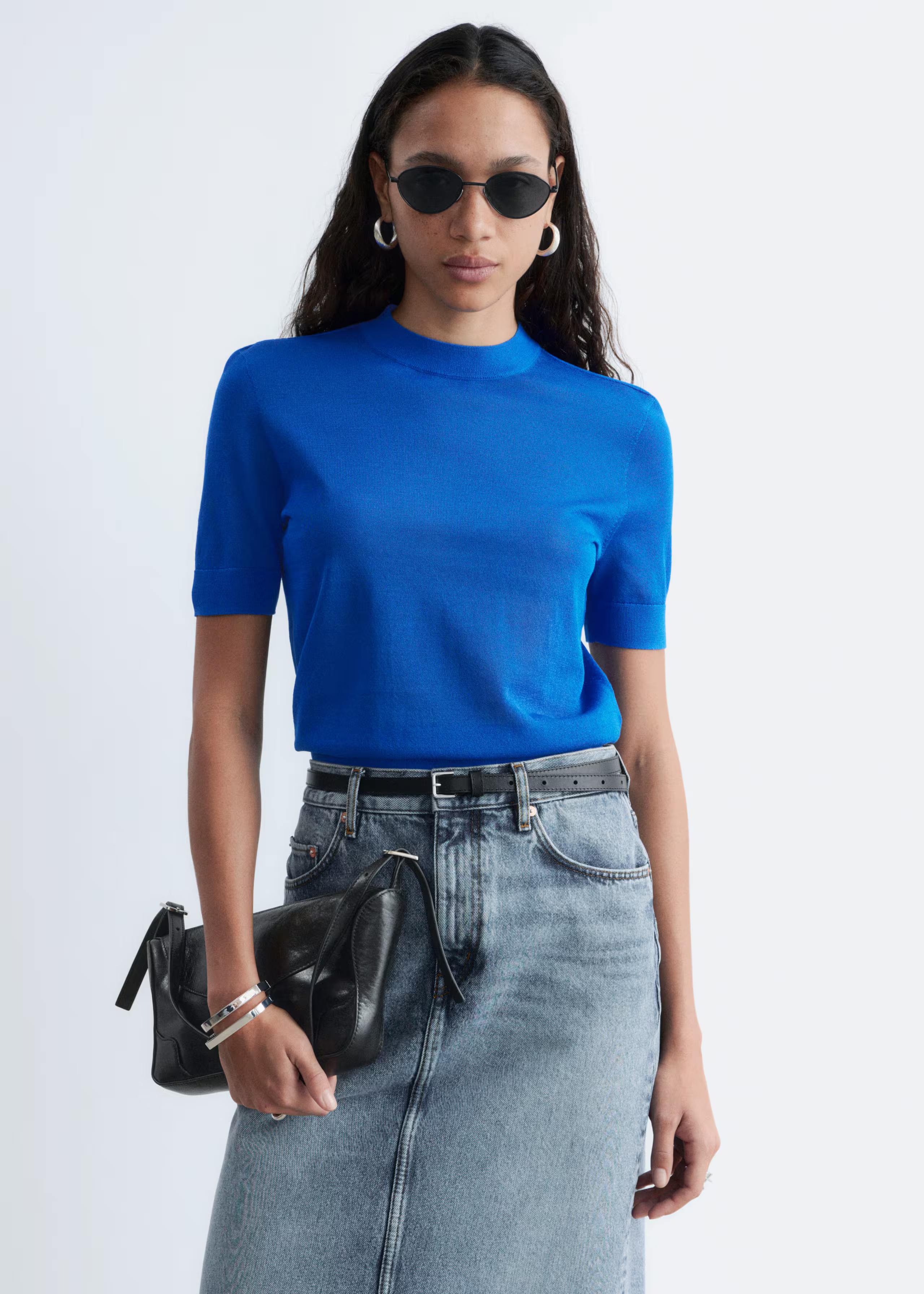 A model wearing a cobalt blue t-shirt from &amp;amp; Other Stories