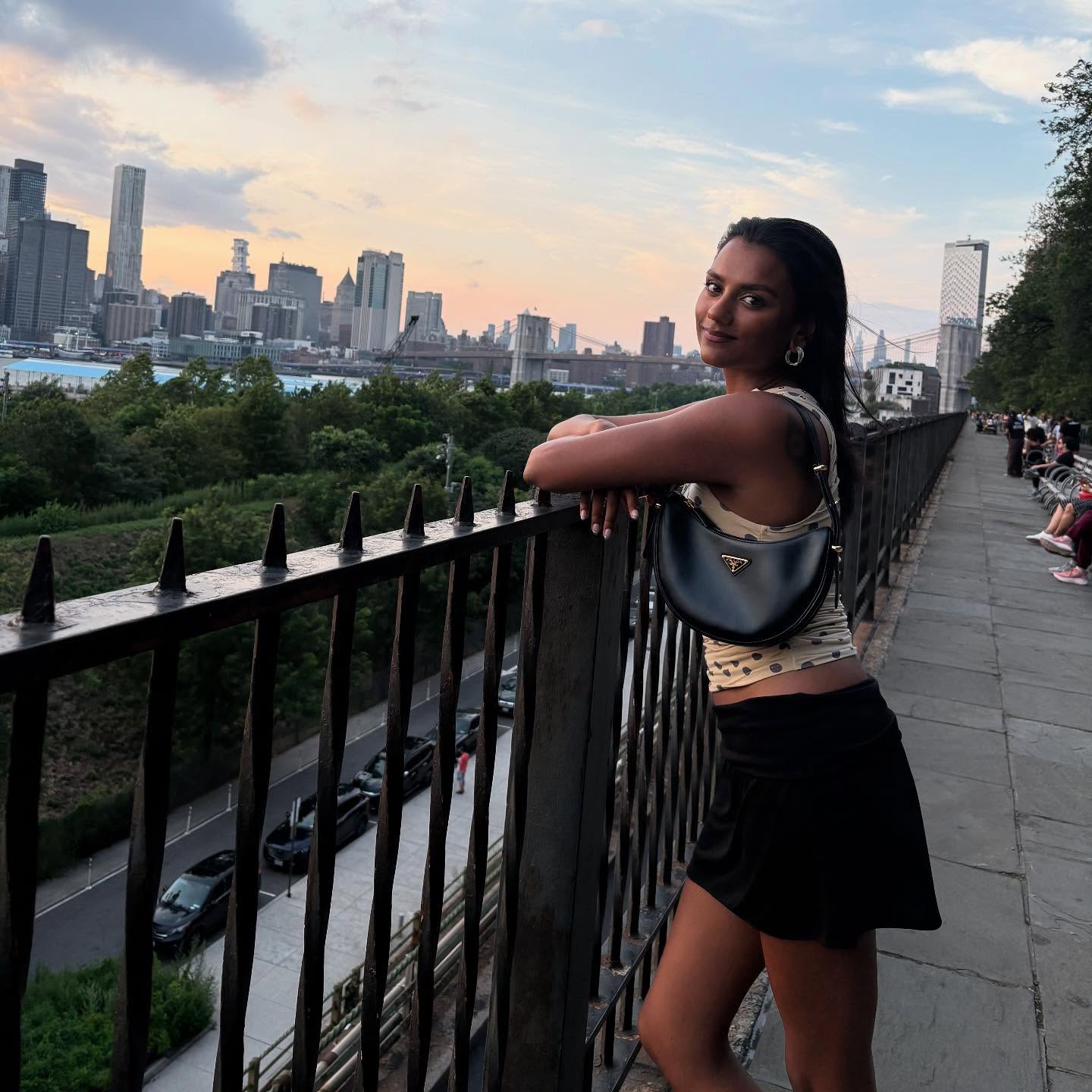 An image of Simone Ashley wearing a polka-dot top with a black mini skirt while in New York.