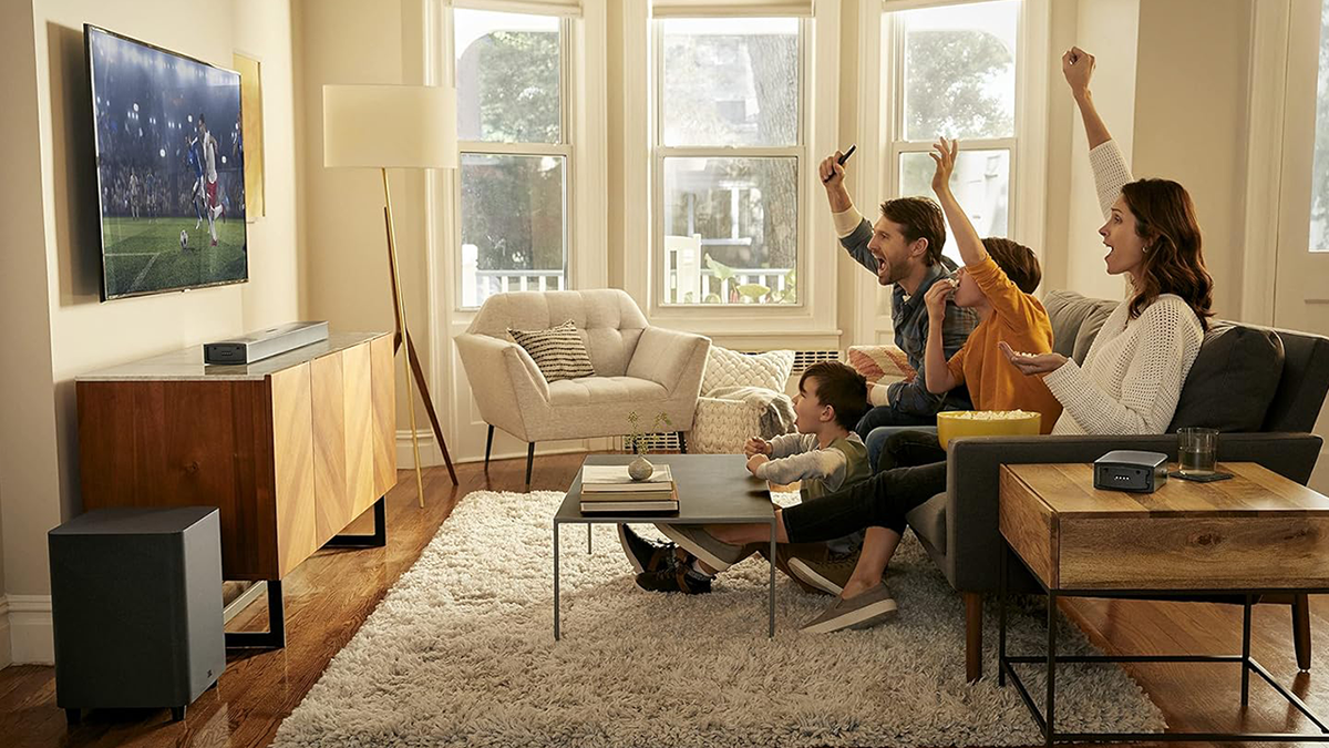 Family watching TV with JBL soundbar