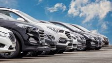 Cars lined up for sale in a car lot.