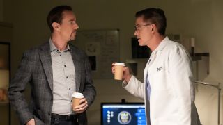 McGee and Palmer holding coffee cups in the morgue in NCIS