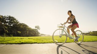 Which muscles are used when cycling? image shows woman riding a bike