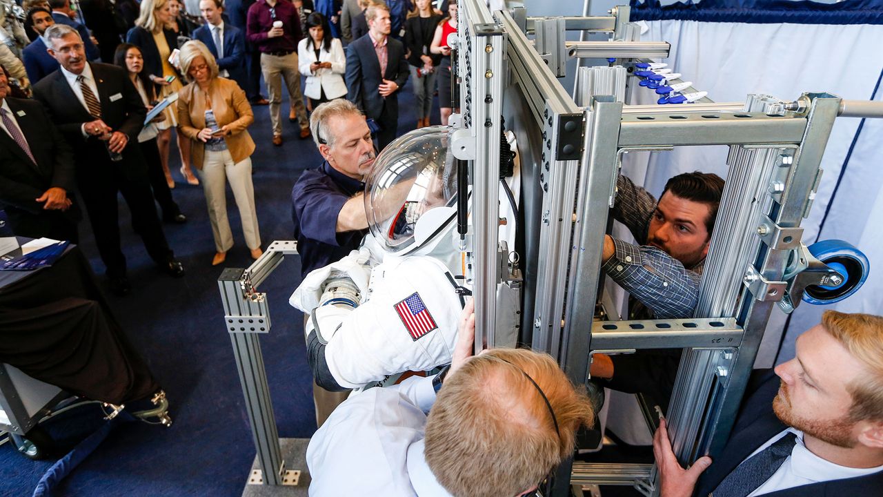 An engineer is secured into the prototype of Collins Aerospace, a unit of United Technologies Corp.'s Next Generation Space Suit system, unveiled during the Space Day on the Hill on Thursday, July 25, 2019 in Washington. The showcase was timed to commemorate the 50th Anniversary of Apollo 11.