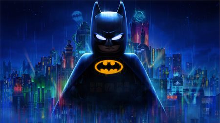 The key art for Lego Batman: Legacy of the Dark Knight showing a shadowed Batman superimposed in front of a neon and spotlight lit Gotham City