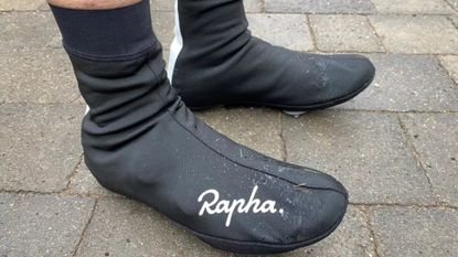 Image shows a rider wearing Rapha's Winter Overshoes.