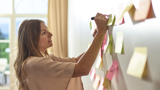 Woman writing on post-it notes